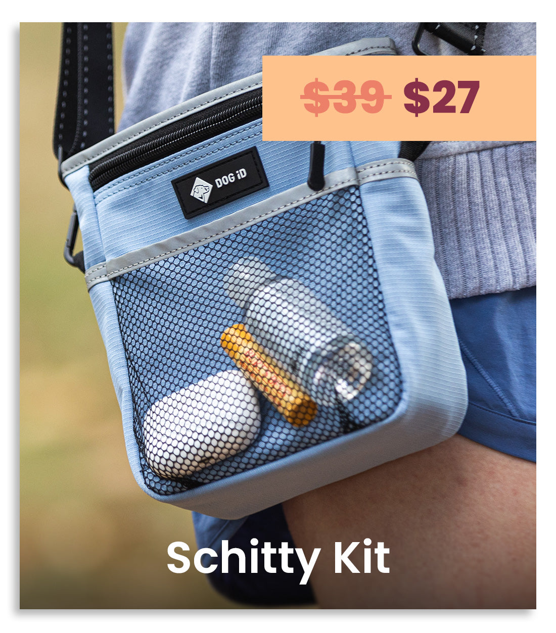A light blue mesh crossbody bag worn on a person's hip, with a black zipper, a black brand patch reading 'DOG ID', and visible contents in the mesh pocket including a white oval item, a clear bottle, and an orange-yellow stick. An orange price badge says '$39-$27' and white text at the bottom reads 'Schitty Kit'.